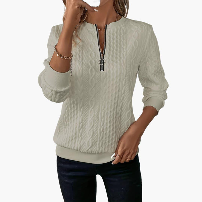 Women's pullover with zipper at the neckline and cable knit pattern surface